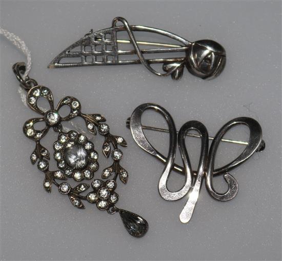 Two silver brooches and a silver and paste pendant.